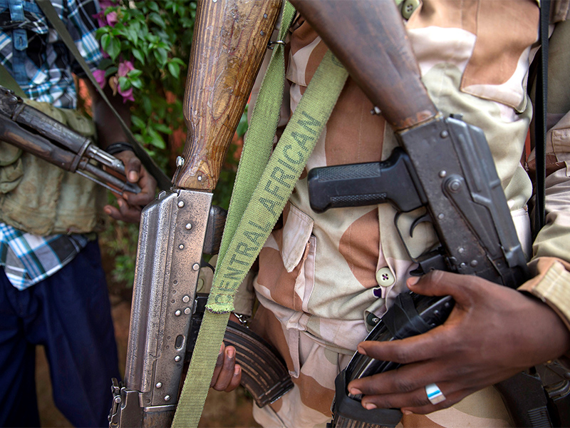 Armed militia fighters display weapons in the town of Koui Central African Republic