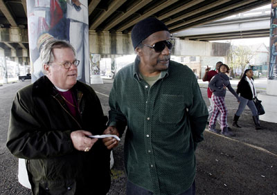 (RNS3-JAN21) New Orleans Episcopal Bishop Charles Jenkins, left, and neighborhood activist Jerome Smith tour Smith's New Orleans neighborhood. Smith has served as Jenkins' unofficial tour guide to the city's black neighborhoods in the wake of Hurricane Katrina. For use with RNS-NOLA-BISHOP, transmitted Jan. 21, 2009. Religion News Service photo by G. Andrew Boyd/The Times-Picayune. 