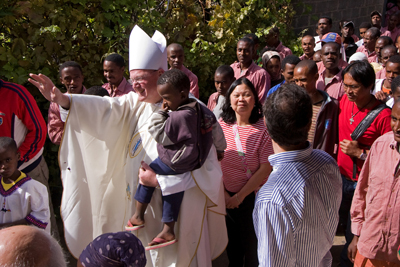 Archbishop Timothy Dolan, who was named Archbishop of New York on Feb. 23, leads a procession following Mass at the Missionaries of Charity home in Addis Ababa, Ethiopia.  