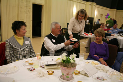 (RNS2-MAR18) Ellen Cortright, a member of Eastminster Presbyterian Church in Simpsonville, S.C., serves cake during a potluck dinner to mark the church's 10-year anniversary. Church officials had to scale back a catered event when ticket prices prooved too expensive for many parishioners. For use with RNS-ECON-CHOICES, transmitted March 18, 2009. Religion News Service photo courtesy Carol B. Stewart. 