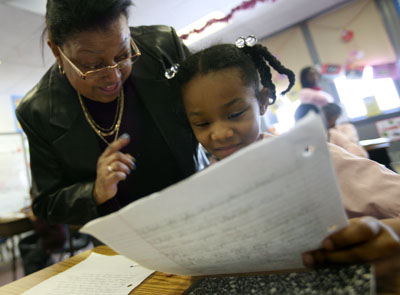 (RNS5-MAY29)  Everlyn Hay, principal of Our Lady Queen of Angels Catholic School in Newark, N.J., discusses a writing assignment with 3rd grade student Rania Evans, 8. For use with RNS-CATHOLIC-SCHOOLS, transmitted May 29, 20009. Religion News Service photo by Jennifer Brown/The Star-Ledger. 