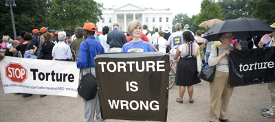 (RNS4-JUNE11) Lavona Grow holds a protest sign during the National Religious Campaign Against Torture rally outside the White House  on Thursday, June 11, 2009. For use with RNS-ANTI-TORTURE, transmitted June 11, 2009. Religion News photo by David Jolkovski. 