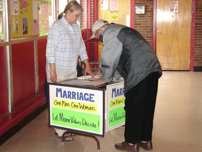 (RNS2-JUNE08) A voter in Brunswick, Maine, signs a petition to overturn a state law that legalized same-sex marriage. Conservative groups have successfully fought same-sex marriage through voter initiatives. For use with RNS-BALLOTS-GAYS, transmitted June 8, 2009. Religion News Service photo courtesy Miriam Conners/StandForMarriageMaine.com 