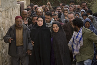 (RNS2-JUNE23) Soraya M. (played by Mozhan Marno), second from left, is accompanied by her aunt, Zahra (played by Shohreh Aghdashloo), second from right, as villagers prepare to stone her for alleged adultery. For use with RNS-STONING-FILM, transmitted June 23, 2009. Religion News Service photo courtesy Grace Hill Media. 
