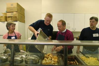 (RNS4-OCT13) Episcopal Bishop V. Gene Robinson, second from right, serves breakfast to the 
homeless during a visit to the Church of the Epiphany in Washington. Robinson, who is openly 
gay, says he is not ``anxious'' about a forthcoming report on his consecration from the Anglican 
Communion. See RNS-GAY-BISHOP, transmitted Oct. 13, 2004. Photo by Jamie Rose. 