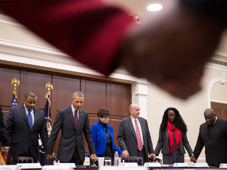 President Barack Obama joins hands with Transportation Secretary Anthony Foxx and Senior Advisor Valerie Jarrett during a prayer with African American faith and civil rights leaders prior to a meeting in the Eisenhower Executive Office Building of the White House, on Feb. 26, 2015. Photo courtesy of The White House/Pete Souza