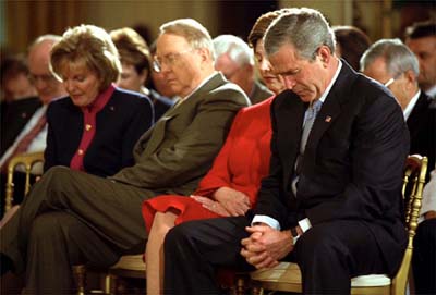President Bush and wife Laura bow their heads along with National Day of Prayer Chairwoman Shirley Dobson and her husband, religious broadcaster James Dobson, at a May 2003 ceremony in the East Room of the White House. President Obama has said he will appeal a federal judge's ruling that the law creating the National Day of Prayer is unconstitutional, even though he declined to host a Bush-style observance at the White House.  