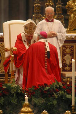 (RNS1) Pope Benedict XVI bestows the pallium (a woolen mantle that denotes the  authority of an archbishop) on Archbishop Donald Wuerl of Washington during a ceremony at the Vatican in 2006. Religion News Service file photo by Joann Keane. 