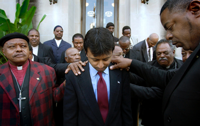 (RNS) New Orleans clergy lay hands on and pray for Bobby Jindal as he ran for governor of Louisiana in 2003. Though he lost that race, he became the nation's first Indian-American governor in 2006. South Carolina's Nikki Haley is poised to join him as the second. RNS file photo by Ted Jackson. 