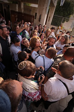 (RNS1-JUL12) Israeli feminist Anat Hoffman, center, was arrested Monday (July 12) at the Western Wall in Jerusalem for carrying a Torah scroll through an area that is restricted to men. For use with RNS-DIGEST-JUL12, transmitted July 12, 2010. RNS photo by Zachary Bennett. 
