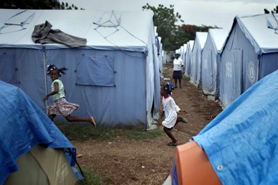 (RNS3-JUL20) A group of girls play tag in the Haitian tent city camp run by Sister Mary Finnick, who has housed as many as 2,000 people at a time in the wake of Haiti's Jan. 12 earthquake. For use with RNS-HAITI-NUN, transmitted July 20, 2010. RNS photo by Aristide Economopoulos/The Star-Ledger. 