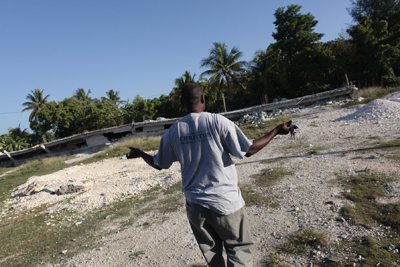 (RNS3-JUL30) Former New York cab driver Jean J. Paul, now a Presbyterian pastor in Haiti, surveyes his former church (now rebuilt) that was flattened in Haiti's Jan. 12 earthquake. None of the more than 50 orphans who live in the Reformation Hope orphanage was killed in the quake. For use with RNS-HAITI-ORPHANS, transmitted July 30, 2010. RNS photo by Matt Rainey/The Star-Ledger. 