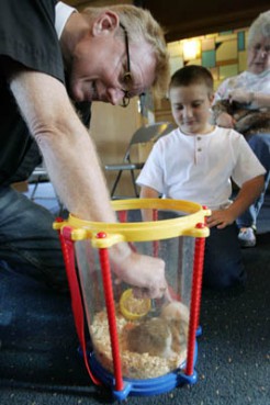 (RNS) Jonathan Wills looks on as the Rev. Donald King blesses the youngster's two hamsters, Whitey and Stanley, at Hope Lutheran Church in Cleveland Heights, Ohio. Religion News Service file photo by Joshua Gunter/The Plain Dealer of Cleveland. 