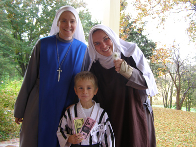 (RNS2-OCT26) Dominic Fatzinger, dressed as St. Maximilian Kolbe, joined an alternative Halloween/All Saints' Day celebration with members of the Servants Of the Lord Novitiate in Upper Marlboro, Md., including one (right) dressed as St. Therese of Lisieux. For use with RNS-HALLOWEEN-SUNDAY, transmitted Oct. 26, 2010. RNS photo courtesy Sam Fatzinger. 