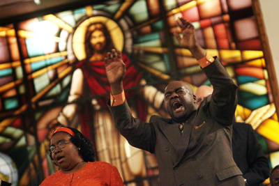 (RNS1-NOV10) Elder Don Glover (right) and Julie Taylor (left) sing during a morning service at Williams Temple Church of God In Christ in St. Louis. COGIC, the nation's largest black Pentecostal denomination, is bringing an estimated 40,000 delegates to downtown St. Louis for a convention. For use with RNS-COGIC-MEET, transmitted Nov. 10, 2010. RNS photo by John L. White/The Post-Dispatch. 