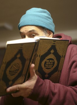 (RNS1-NOV29) Mohammed Moussaoui reads a passage from the Quran for a visitor at the Salman Alfarisi Islamic Center in Corvallis after a suspected arson broke out at the mosque when an OSU Muslim student was charged with plotting to detonate a bomb at the Christmas tree lighting ceremony in Portland. For use with RNS-MOSQUE-ARSON, transmitted Nov. 29, 2010. RNS photo by Ross William Hamilton/The Oregonian. 