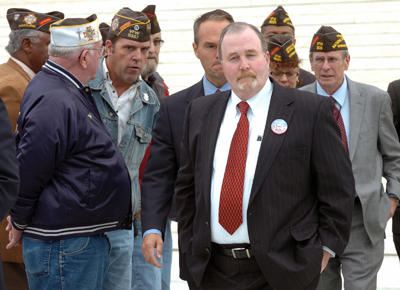 (RNS) Albert Snyder, center, is surrounded by veterans as he exits the Supreme Court after justices considered the limits of free speech surrounding an anti-gay church that picketed outside Snyder's son's military funeral. The court ruled March 2 for the picketers in an 8-1 decision. RNS file photo by Paul Kuehnel/York Daily Record/Sunday News. 