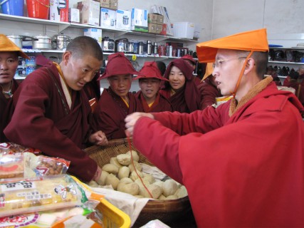 (RNS3-NOV07) Ye Liping, right, sells rolls at a store at the remote Larung Gar Buddhist Institute in Serthar, China. Two years ago, Ye left his business and family for the monastic hardships of life at Larung Gar. For use with RNS-CHINA-BUDDHISM, transmitted Nov. 7, 2011. RNS photo by Calum MacLeod/USA Today. 