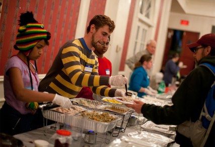 (RNS1-NOV29) Volunteer Matthew Streib, 29, part of Occupy Church D.C., serves food at the Occupy Faith D.C. Thanksgiving meal, at New York Avenue Presbyterian Church in Washington, D.C. For use with RNS-OCCUPY-FAITH, transmitted Nov. 29, 2011. RNS photo by Lauren Pond. 