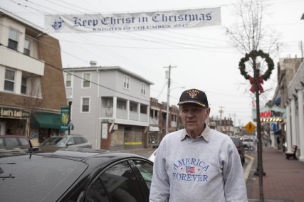 (RNS1-DEC23) Jim Dougherty is a  Christian who is in favor of the sign hanging above Broadway in the town of Pitman, N.J. An anonymous atheist says the sign demonstrates an unconstiutional favoritism toward Christians. For use with RNS-CHRISTMAS-COMPLAN, transmitted Dec. 23, 2011. Religion News Service photo by Stefanie Campolo/The Star-Ledger. 