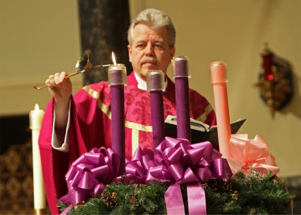 (RNS3-DEC18) The Rev.  Joseph Schlafer lights the first candle in an Advent wreath at St. Joseph Church in Garden City, N.Y.  For use with RNS-CHURCHES-ADVENT, transmitted Dec. 8, 2011. RNS photo by Gregory A. Shemitz. 