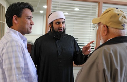 (RNS3-JAN18) Imam Asif Umar (center) talks with Amil Rajput (left) and Syed Rahman (right)  following Friday prayers at the Daar-Ul-Islam mosque in St. Louis. For use with RNS-AMERICAN-IMAM, transmitted Jan. 18, 2012. RNS photo by Johnny Andrews/St. Louis Post-Dispatch. 