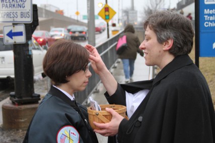 The Rev. Kara Wagner Sherer of St. John's Episcopal Church in Chicago imposes ashes on a passerby in 2011 as part of a growing "Ashes to Go" program in the Episcopal Church.   