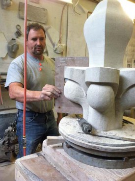 Andy Uhl, a stone carver at the Washington National Cathedral, checks the contours of a limestone finial that will replace one severely damaged in the Aug. 23 earthquake.   
