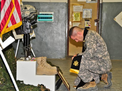 Army Chaplain Capt. Joseph Odell mourns a fallen soldier in Afghanistan.  