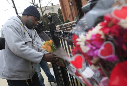 Michael Nash of Newark, N.J., leaves flowers at  a make-shift memorial outside the New Hope Baptist Church, where singer Whitney Houston honed her talents in the choir. 