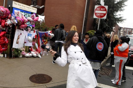 Entertainment Tonight correspondant Christina McLarty laughs while outside New Hope Baptist Church in Newark, N.J., where Whitney Houston's funeral will be held on Saturday.   