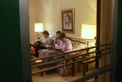 Alison McCrary, center, prays with Sisters Theresa Pitruzello, left, and Helen Prejean, right, as she studies to become a nun with the Sisters of St. Joseph.   