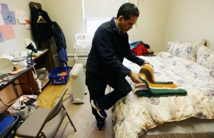 Saul Timisela, 45, who has taken refuge from deportation at the Reformed Church of Highland Park, folds a prayer rug his room at the church on Thursday, March 15, 2012. Timisela is an Indonesian Christian who fears religious persecution if deported back to Indonesia, one of the world's largest Islamic countries. 