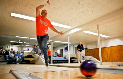Gary Heinz lets go of the bowling ball at the St. Boniface Bowling Alley underneath St. Ann Catholic Church in Peoria, Ill. 
