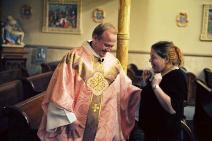 Patricia Darek lets out a small cheer as she talks with the Rev. Marek Bozek following a celebratory Mass at St. Stanislaus Kostka Church in St. Louis, after a judge ruled in the church's favor in a decade-long dispute between the historic Polish church and the Archdiocese of St. Louis. 