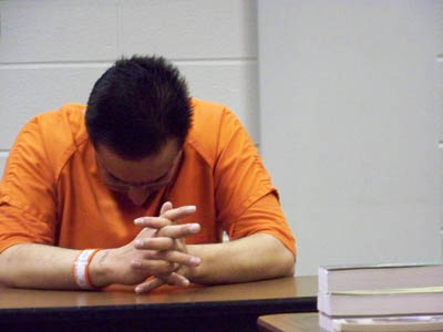 A detainee prays at the McHenry County Correctional Facility in Woodstock, Ill., where more than half of the inmates are being held on immigration violations.   