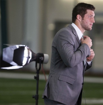 Quarterback Tim Tebow preapres to address the media during his debut with the New Jersey Jets in Florham Park, N.J., on March 26, 2012. 