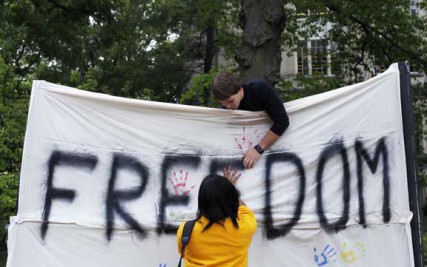 Storm Ervin (below) places her handprint on the canvas freedom banner at the Freedom Movement booth on the University of Missouri campus Monday, April 23. The Freedom Movement is part of a nationwide effort on university campuses to end human trafficking.  