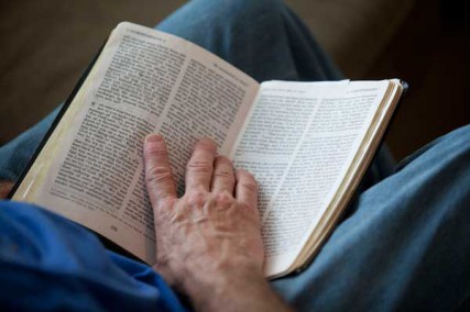Bruce Boling, holds a Bible open while participating in a Bible study group in Gallatin, Tenn., Sunday, April 1, 2012. 