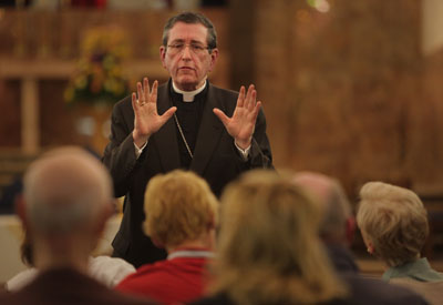 Bishop Richard Lennon of Cleveland implored a group of protesters to vacate the closed St. John the Baptist Church in Akron during the church's final Mass in 2010.   