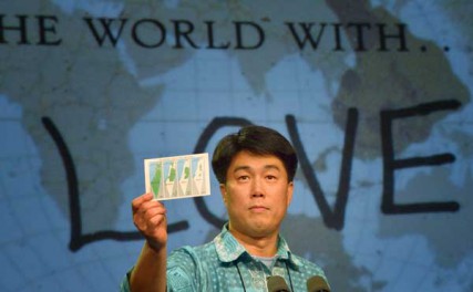 The Rev. We Hyun Chang, a pastor in Belmont, Mass., and a delegate from the New England annual conference, holds a map of Israeli encroachment of the West Bank as he presents a minority report during the May 2 session of the 2012 United Methodist General Conference in Tampa, Florida. Chang presented a motion favoring divestment from corporations profiting from the illegal Israeli settlement of occupied Palestinian territories. The move was defeated. 