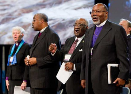 Pan-Methodist church leaders join together at the 2012 United Methodist General Conference in Tampa, Fla. on May 1, 2012. From left are: Bishop Sharon Zimmerman Rader, United Methodist Church; Bishop Thomas Hoyt Jr., Christian Methodist Episcopal Church; the Rev. W. Robert Johnson III, African Methodist Episcopal Zion Church; and Bishop John F. White, African Methodist Episcopal Church. 