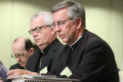 U.S. bishops gather for their annual mid-year meeting June 13 in Atlanta. Pictured from right are Bishop Peter F. Christensen of Superior, Wis.; Auxiliary Bishop Donald J. Hying of Milwaukee; and Bishop Thomas J. Olmsted of Phoenix. 