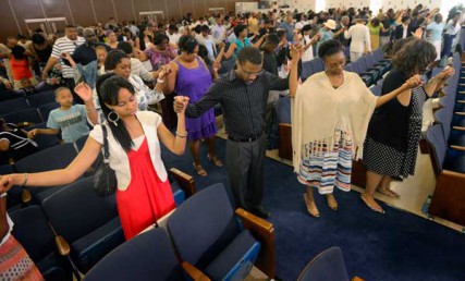 Congregants pray at Colonial Baptist Church in Randallstown, Maryland, on Sunday, June 10, 2012. 