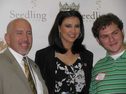 Miss America Laura Kaeppeler smiles for the cameras with mentor Ruben V. Castaneda (left) and his mentee, Riley Chandler, whose father is incarcerated. The photo session was part of her May visit to the Seedling Foundation's annual mentor appreciation luncheon. 