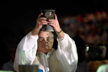 Bishop Larry M. Goodpaster lifts a chalice high during the consecration of the elements in the April 24 opening worship service of the 2012 United Methodist General Conference in Tampa, Florida. 