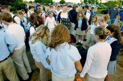 Students join hands as they pray in groups around the flagpole at Baker High School in Mobile, Ala., on Wednesday (Sept. 17, 2003). The annual ``See You at the Pole'' observance is just one example of the intersection of religion and public schools across the country. 