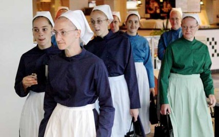 Amish women enter the federal courthouse in Cleveland for the beginning of the trial of 16 Amish defendants -- 10 men with full beards, six women in white bonnets -- who are on trial on charges related to a series of beard- and hair-cutting attacks against fellow Amish men and women last year. 