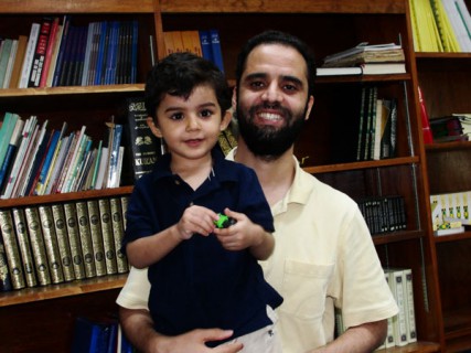 After four years of living in the U.S., Mohamed Jedeh (pictured here with his son inside the Yusuf Mosque in Boston) is anxious to return to his native Libya. 