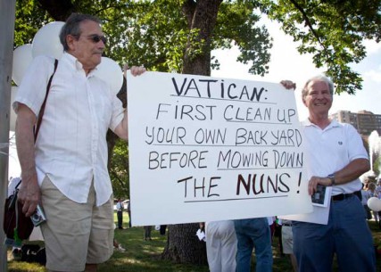 (Left) Vern Barnet, a member of Episcopalian Grace and Holy Trinity Church in Kansas City and Brother Jim Krause (right) of St. Anthony hold a sign addressing the Vatican during a rally to honor American nuns at J.C. Nichols Memorial Fountain on the Country Club Plaza in Kansas City, Mo. on Tuesday June 19, 2012.  The event was organized by local residents and the nationwide organization Call to Action, a Catholic movement working for equality and justice in the Church and society. 